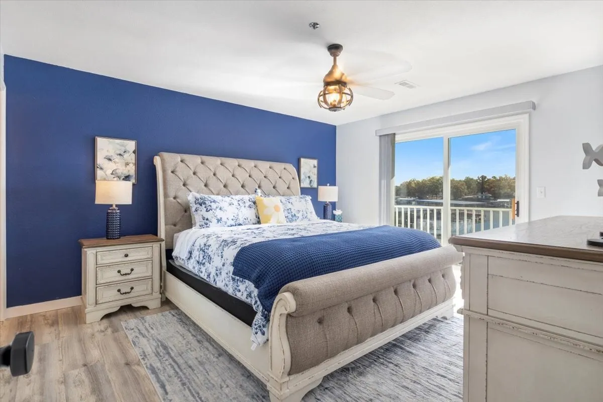 A serene bedroom with a comfortable bed, window view, nightstand, and chest of drawers. The ambiance is peaceful and cozy, ideal for unwinding, reading, or enjoying a quiet morning coffee.