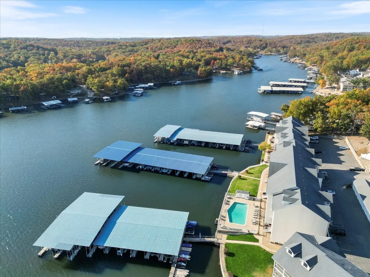 This shot captures the marina docks, swimming pool, and surrounding foliage, blending water-based adventure with relaxation by the pool. The image conveys a sense of community and versatility in outdoor activities, from fishing to swimming.